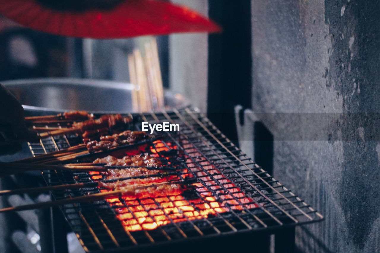 CLOSE-UP OF MEAT ON BARBECUE