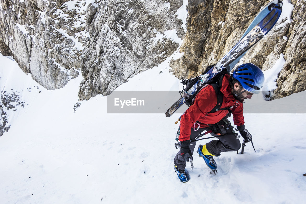 High angle view of man hiking during winter