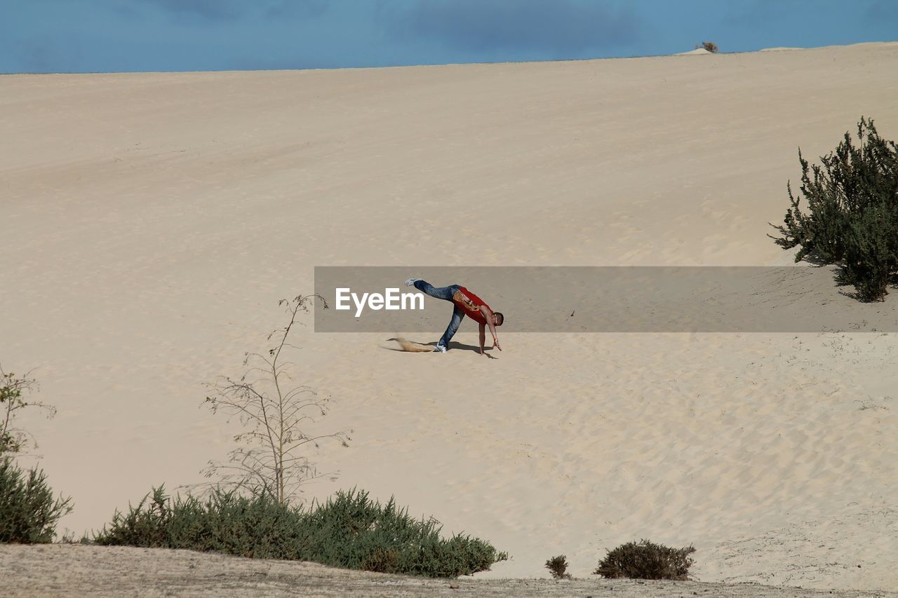 Man performing stunt in desert