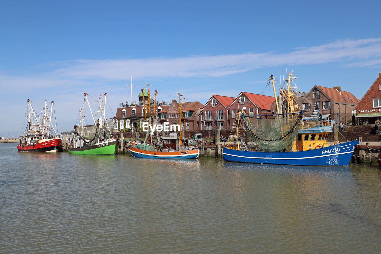 BOATS MOORED AT HARBOR