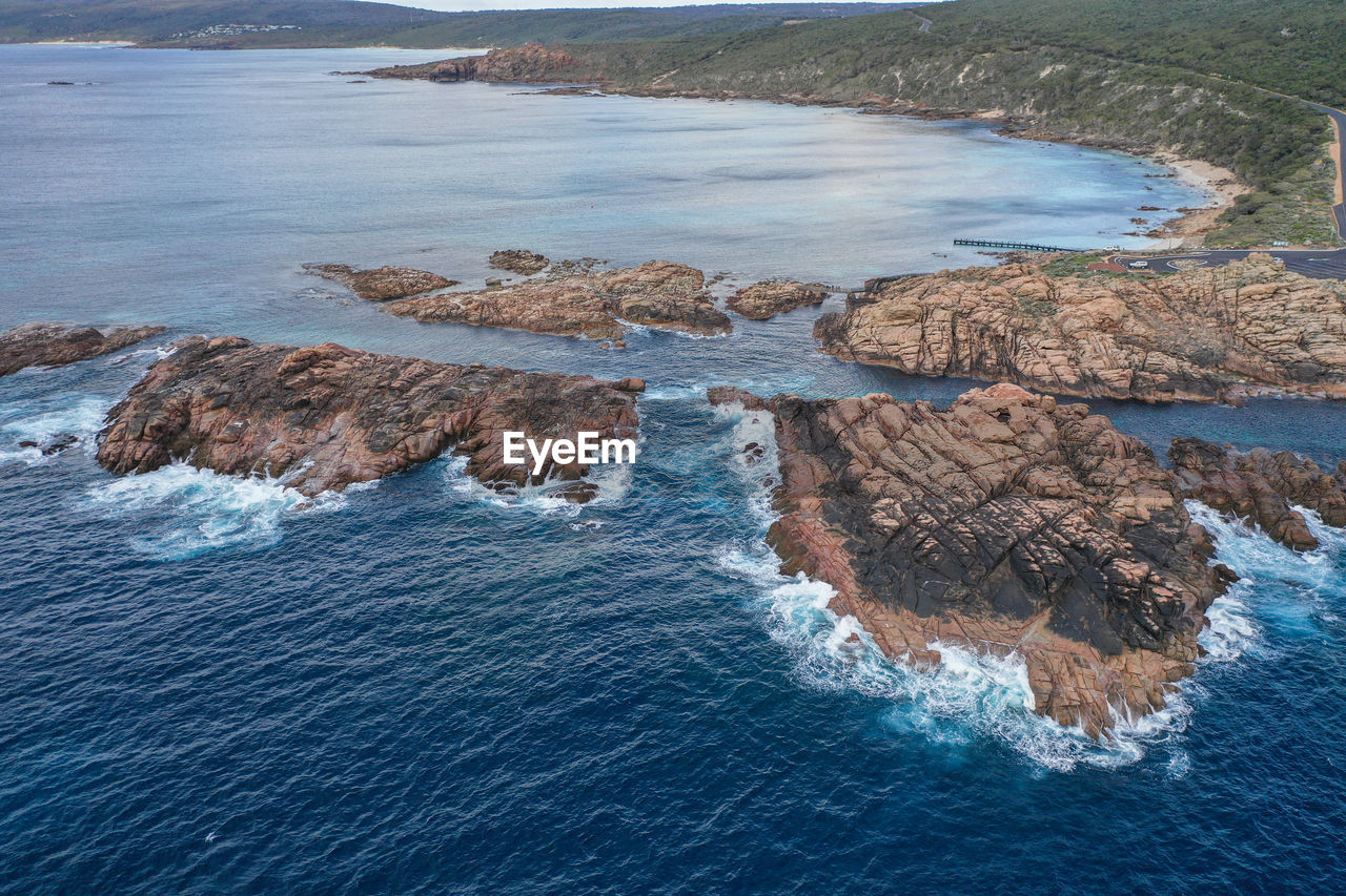 high angle view of rocks on sea