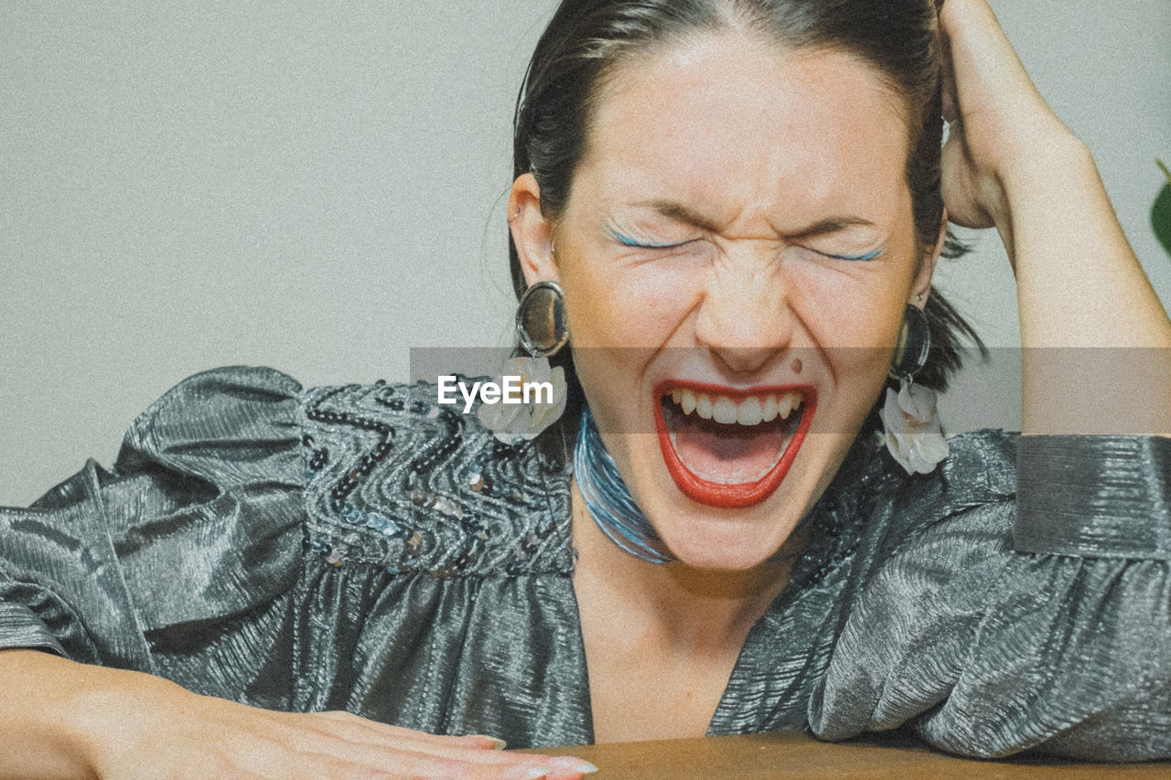 Close-up of young woman shouting