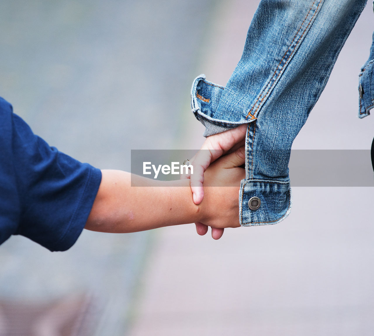 Cropped hand of mother holding son