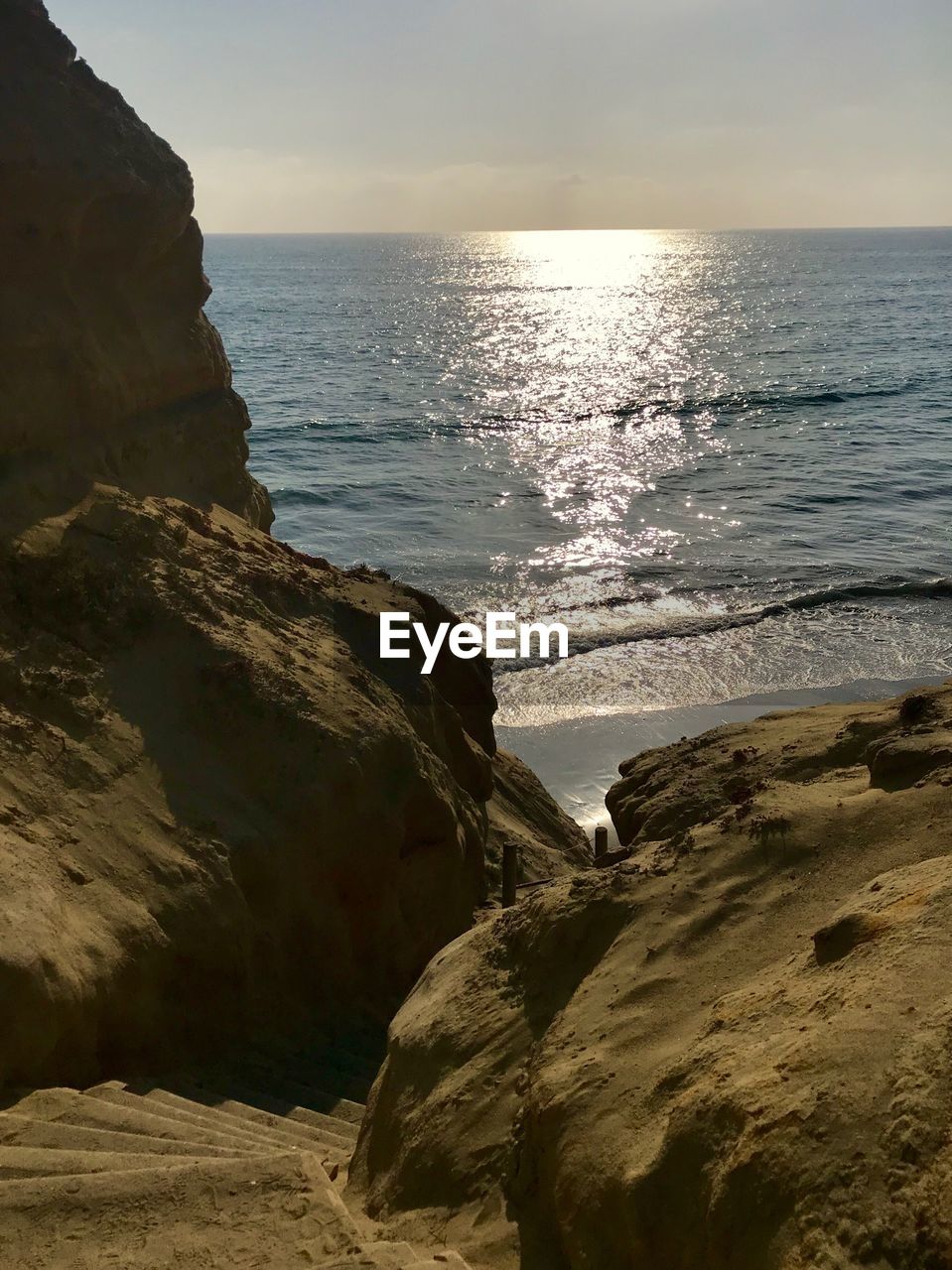 SCENIC VIEW OF SEA BY CLIFF AGAINST SKY