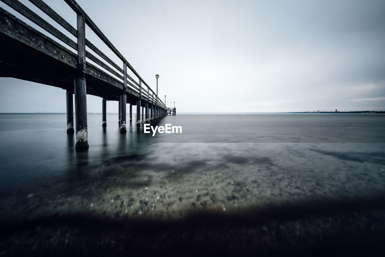 Pier over sea against sky