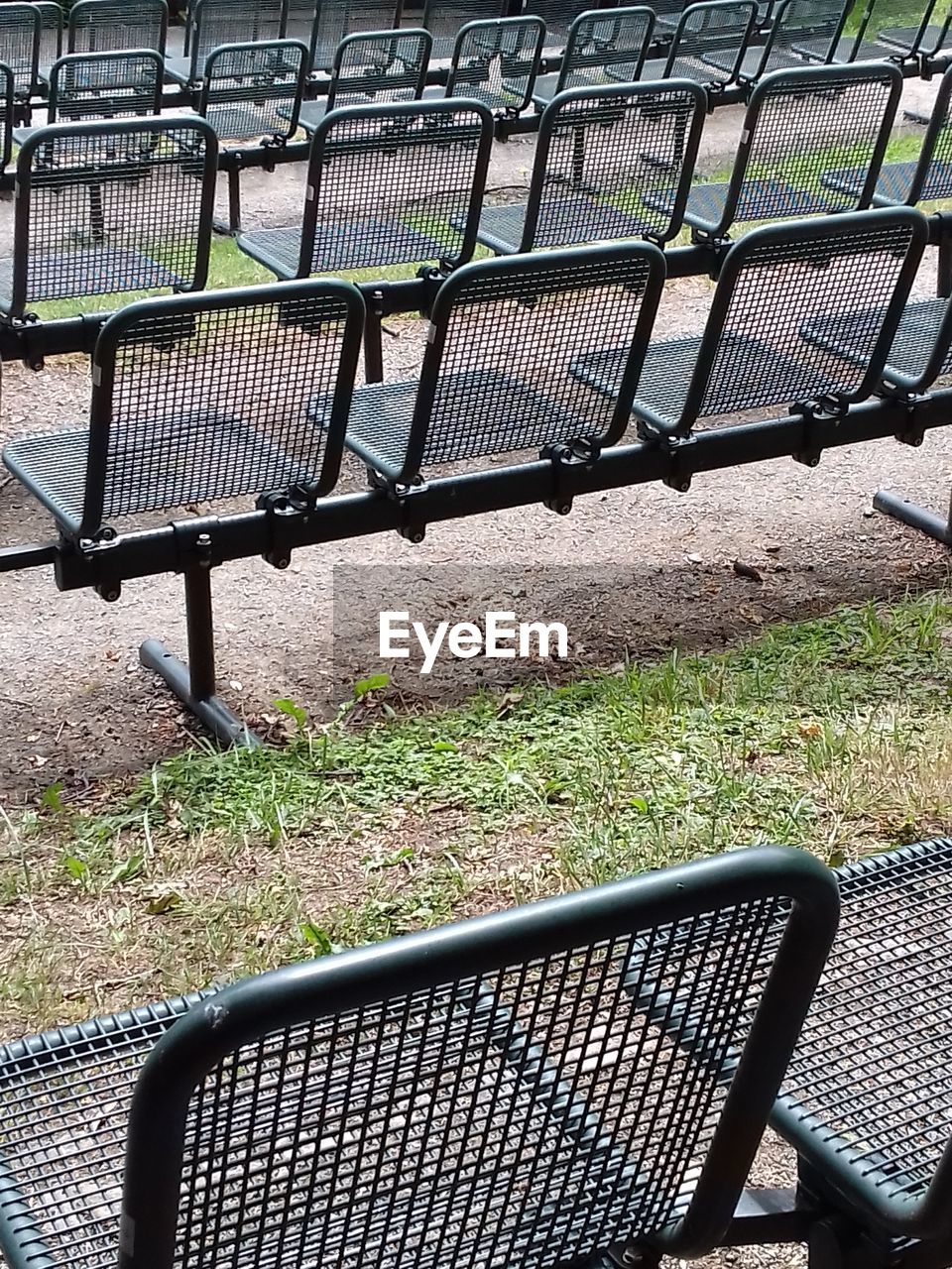 EMPTY BENCH IN PARK DURING RAINY SEASON