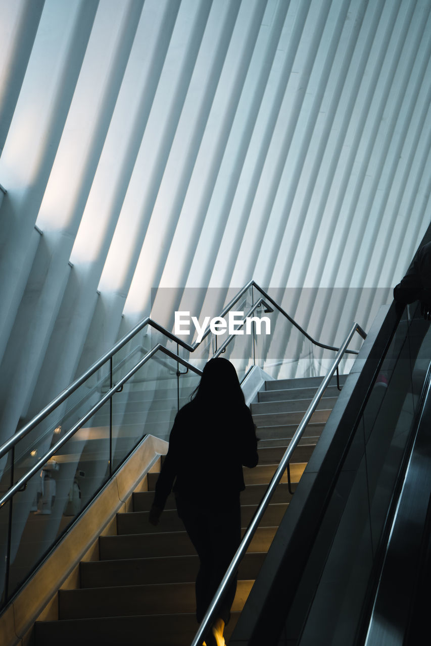 Young woman walking in a modern building landscape