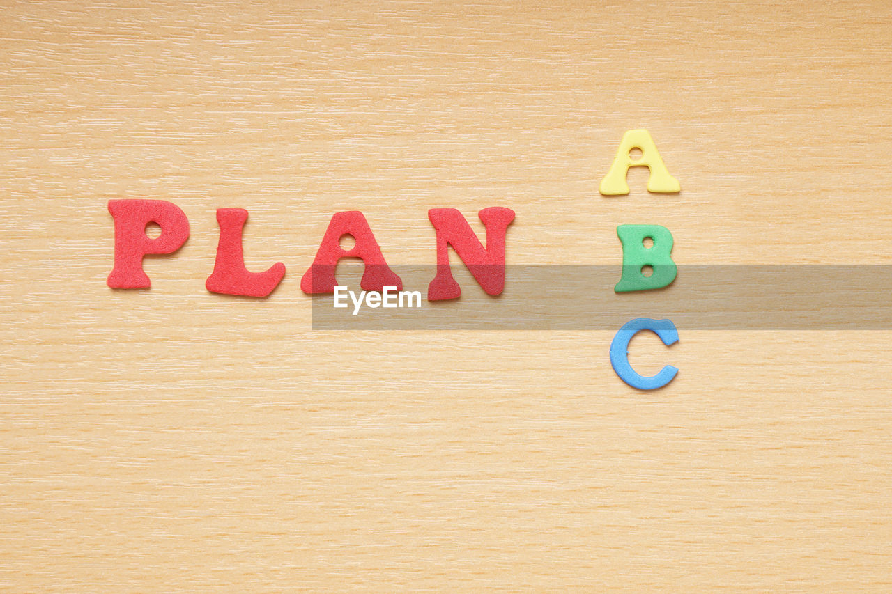 High angle view of colorful plan text on wooden table