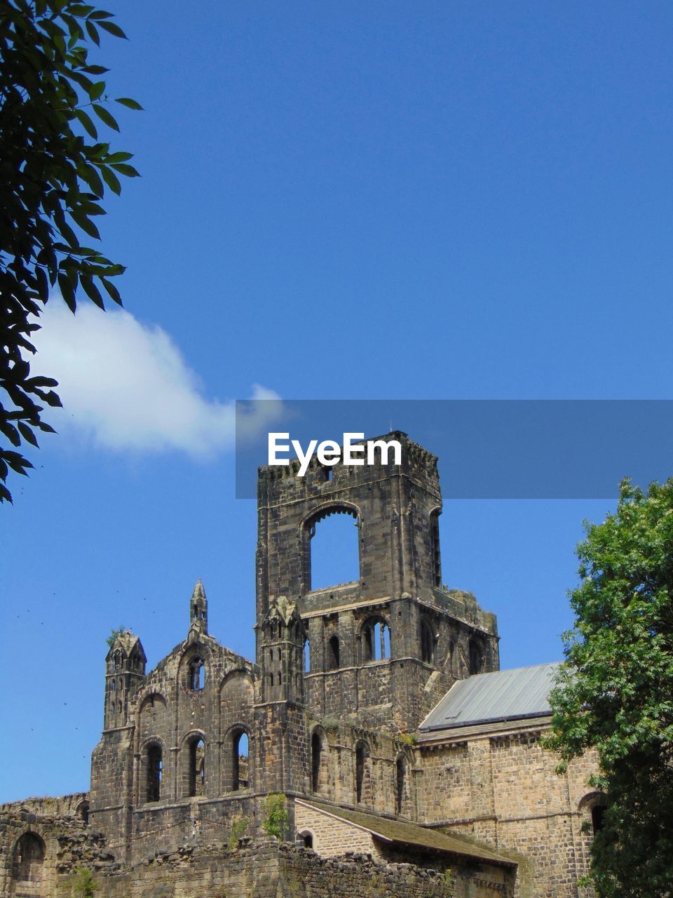 Low angle view of historical building against blue sky