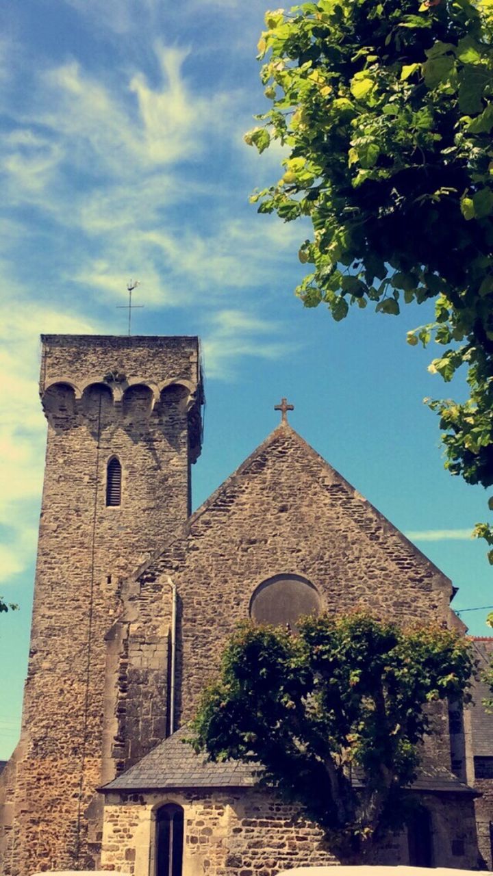 LOW ANGLE VIEW OF CHURCH WITH TREES IN BACKGROUND