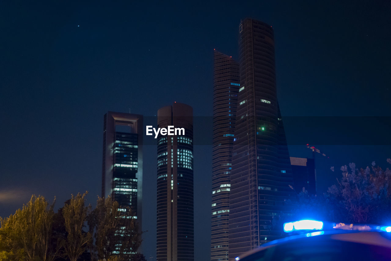 Police car next to madrid's skyscraper