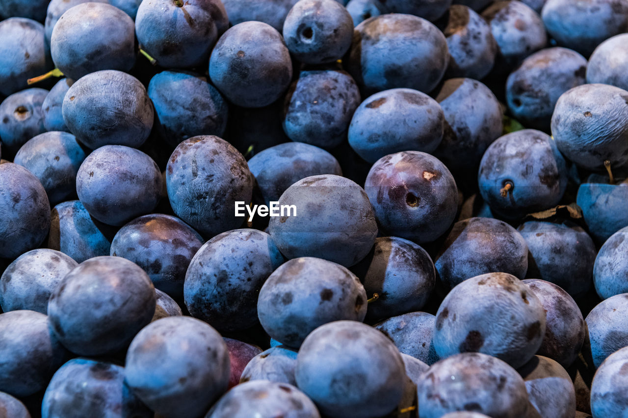 Ripe plums in market for sale