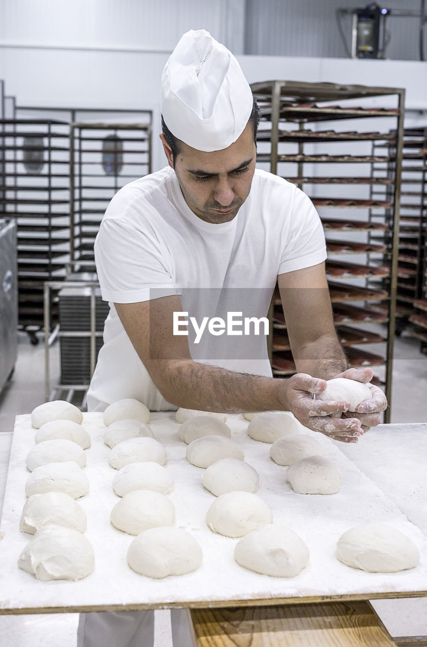 Baker making breads in bakery