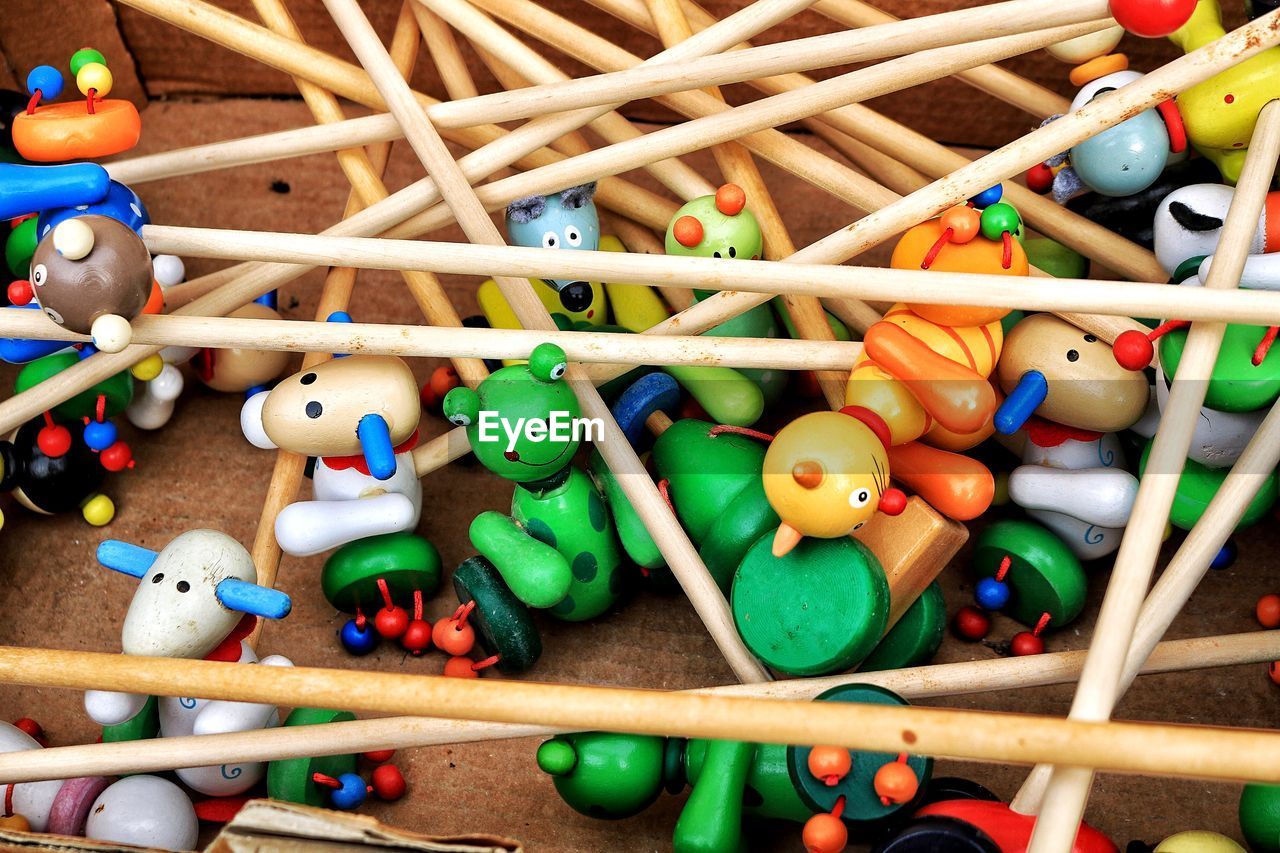 HIGH ANGLE VIEW OF VARIOUS TOYS ON WOOD IN SHELF