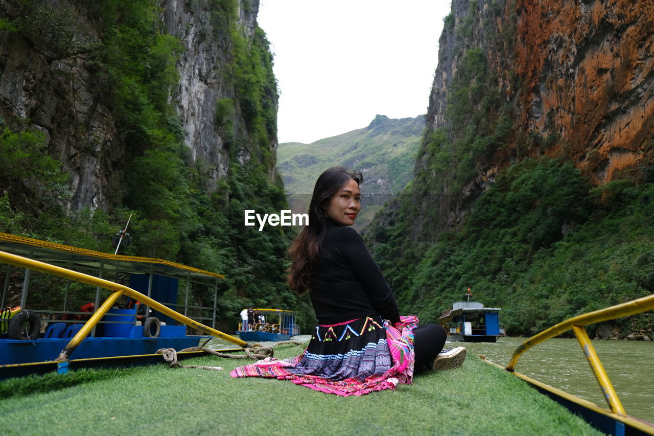 Portrait of young woman standing on mountain