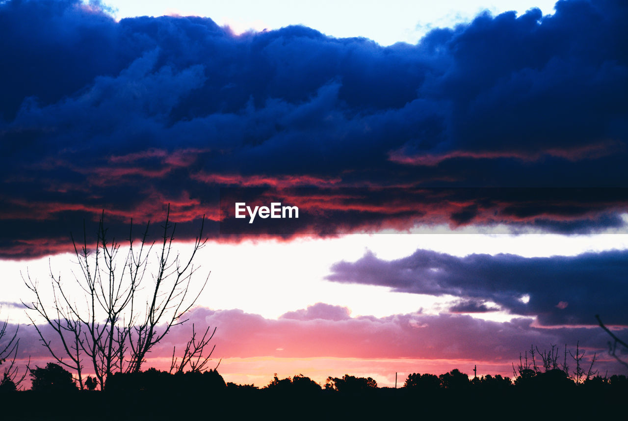 SCENIC VIEW OF SILHOUETTE LANDSCAPE AGAINST DRAMATIC SKY