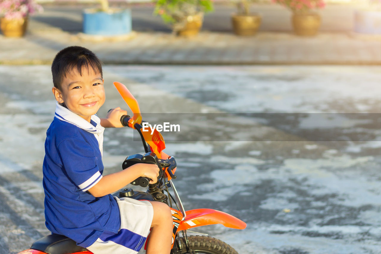 Smiling boy on motorcycle during winter