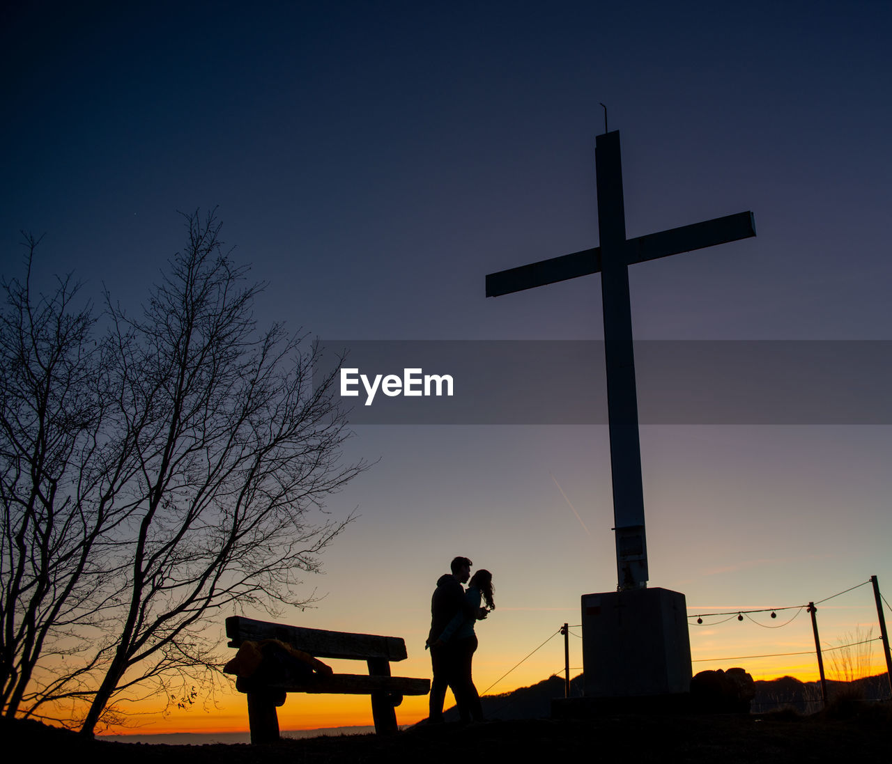 silhouette, grave, religion, belief, cross, sky, cemetery, spirituality, sadness, sunset, nature, dusk, grief, crucifix, symbol, cross shape, death, evening, catholicism, person, architecture, back lit, praying, emotion, place of worship, men, adult, cloud, outdoors, night, forgiveness