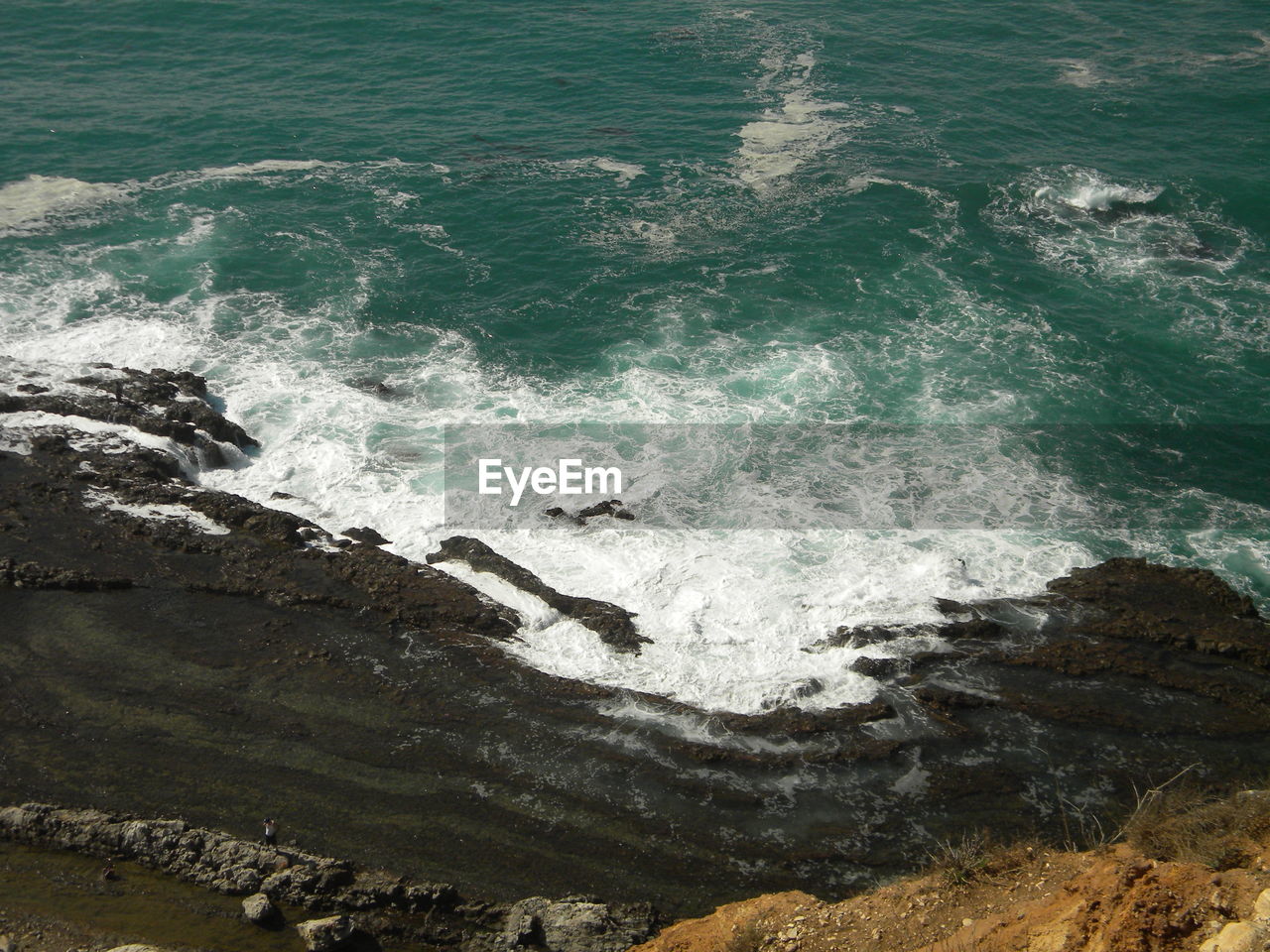 High angle view of waves splashing in sea