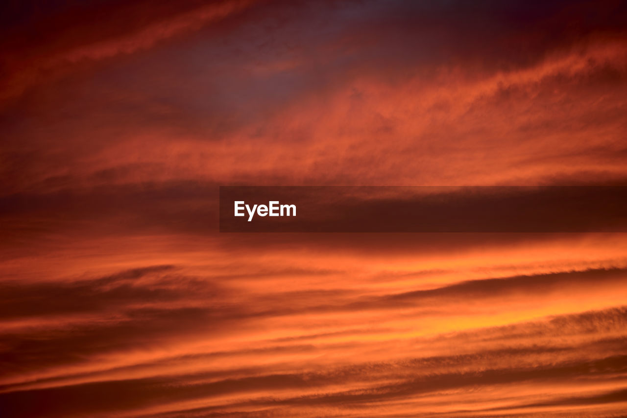 sky, cloud, sunset, dramatic sky, beauty in nature, red sky at morning, afterglow, backgrounds, orange color, nature, scenics - nature, cloudscape, no people, tranquility, horizon, environment, idyllic, moody sky, tranquil scene, atmosphere, outdoors, awe, dark, abstract, storm, vibrant color, evening, dawn, sunlight, red, overcast, multi colored, light - natural phenomenon, copy space, twilight, atmospheric mood, abstract backgrounds