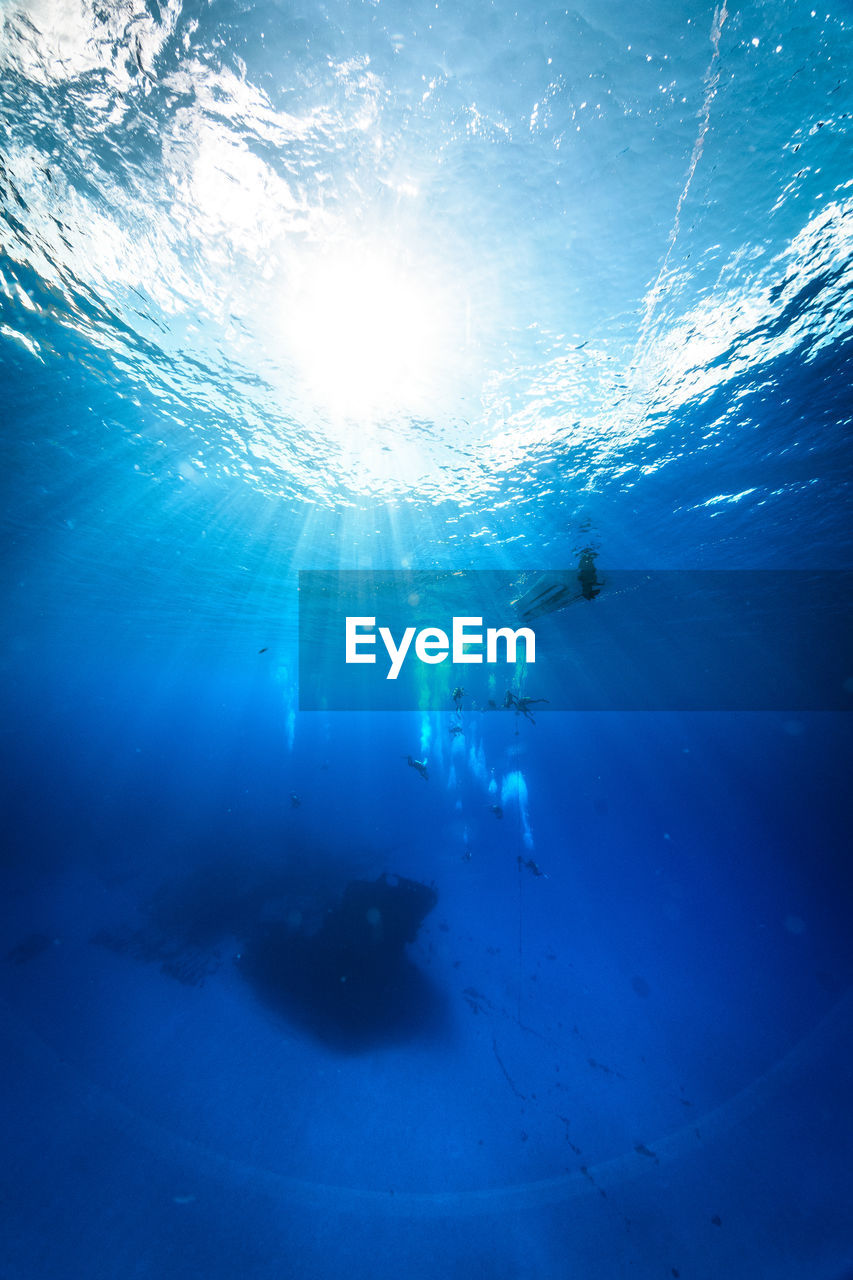 Low angle view of people swimming in sea