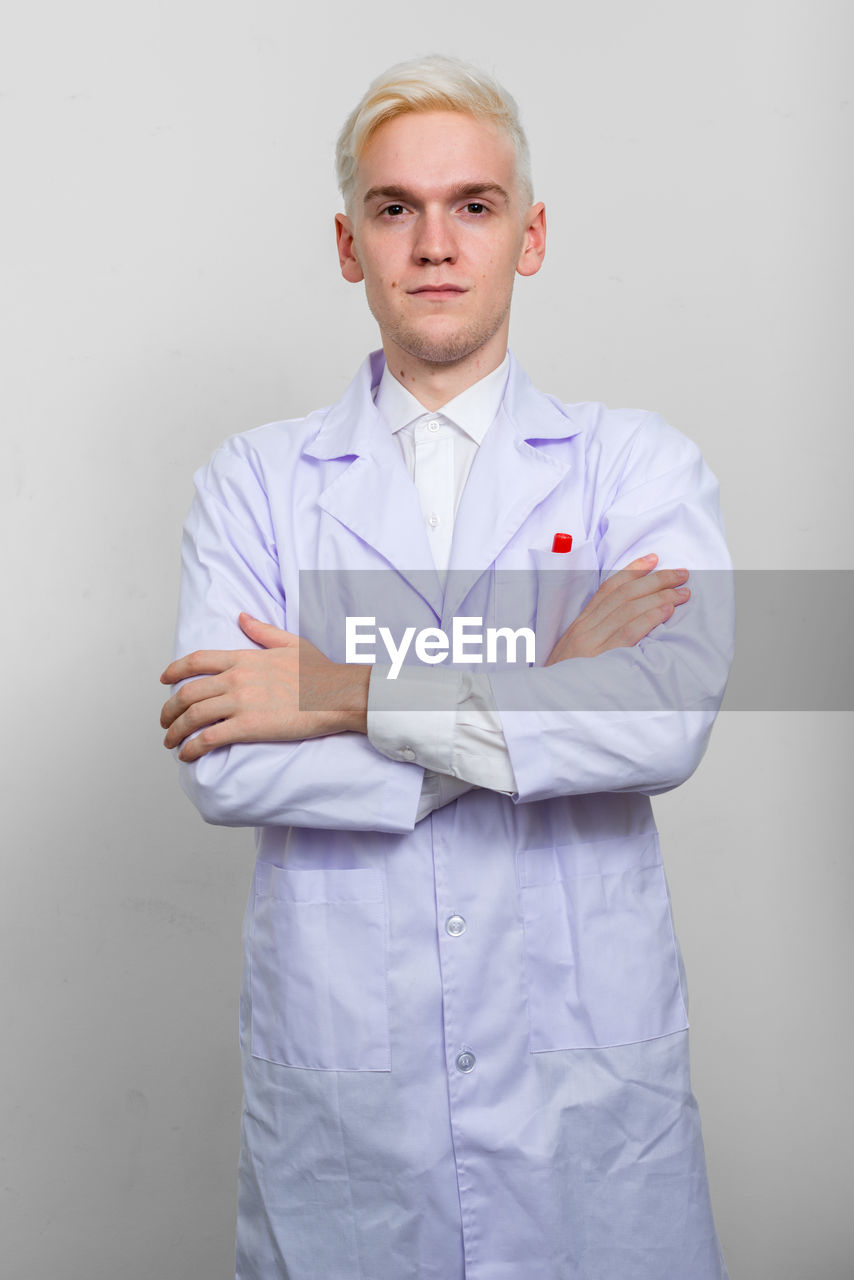 Portrait of doctor standing acting white background