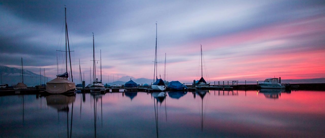 View of boats at harbor during sunset