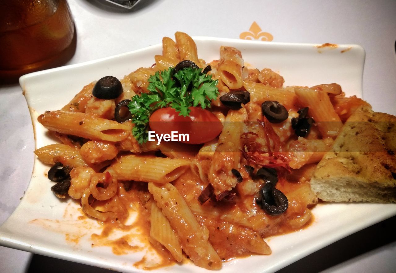 CLOSE-UP OF SERVED FOOD IN PLATE WITH SAUCE