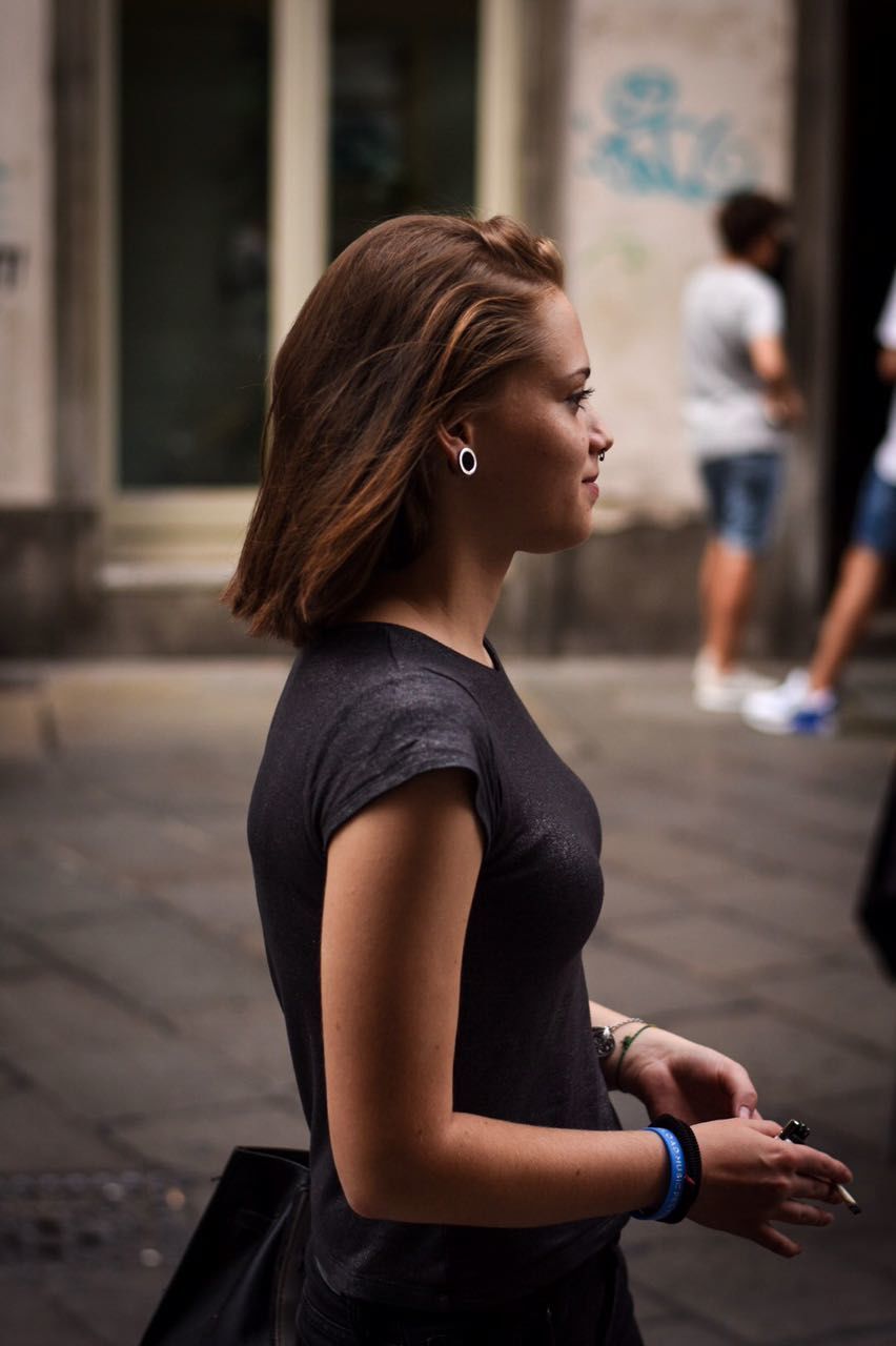 Close-up of young woman in city