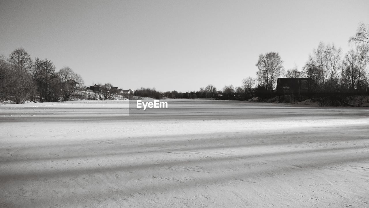 TREES ON SNOW COVERED FIELD AGAINST SKY
