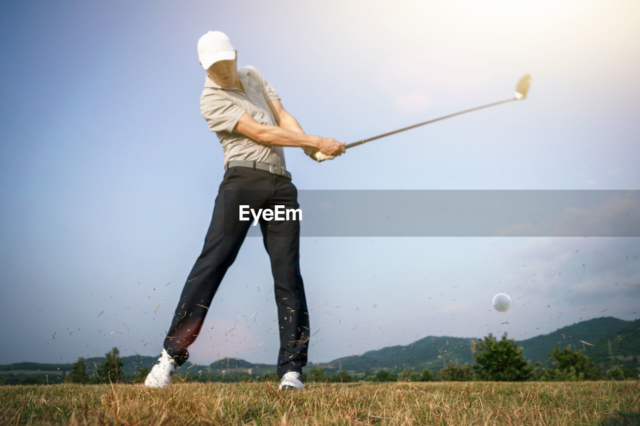 Man playing with ball against sky