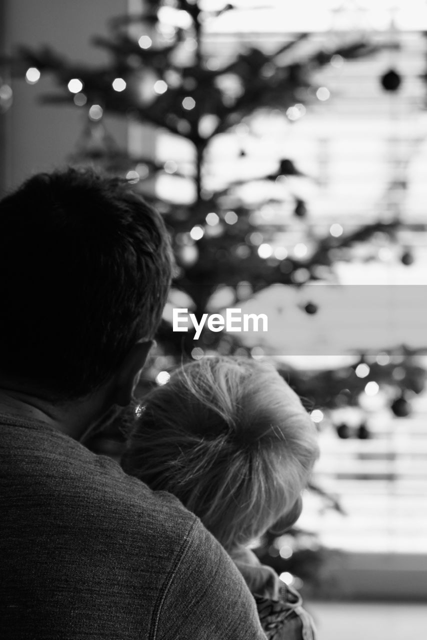 black, rear view, two people, men, adult, togetherness, love, christmas tree, emotion, positive emotion, white, child, women, black and white, family, childhood, bonding, headshot, monochrome, focus on foreground, lifestyles, tree, female, monochrome photography, christmas, winter, portrait, parent, celebration, holiday, embracing, father, leisure activity, romance, happiness, nature, casual clothing, affectionate, decoration, outdoors