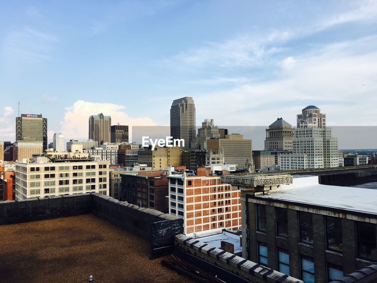 View of cityscape against cloudy sky