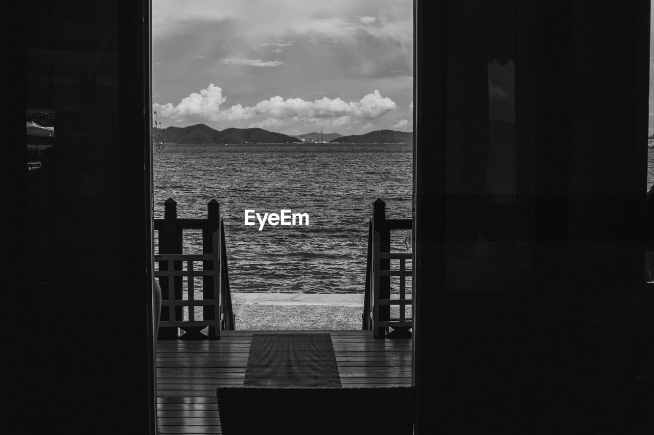 Scenic view of sea seen through open door