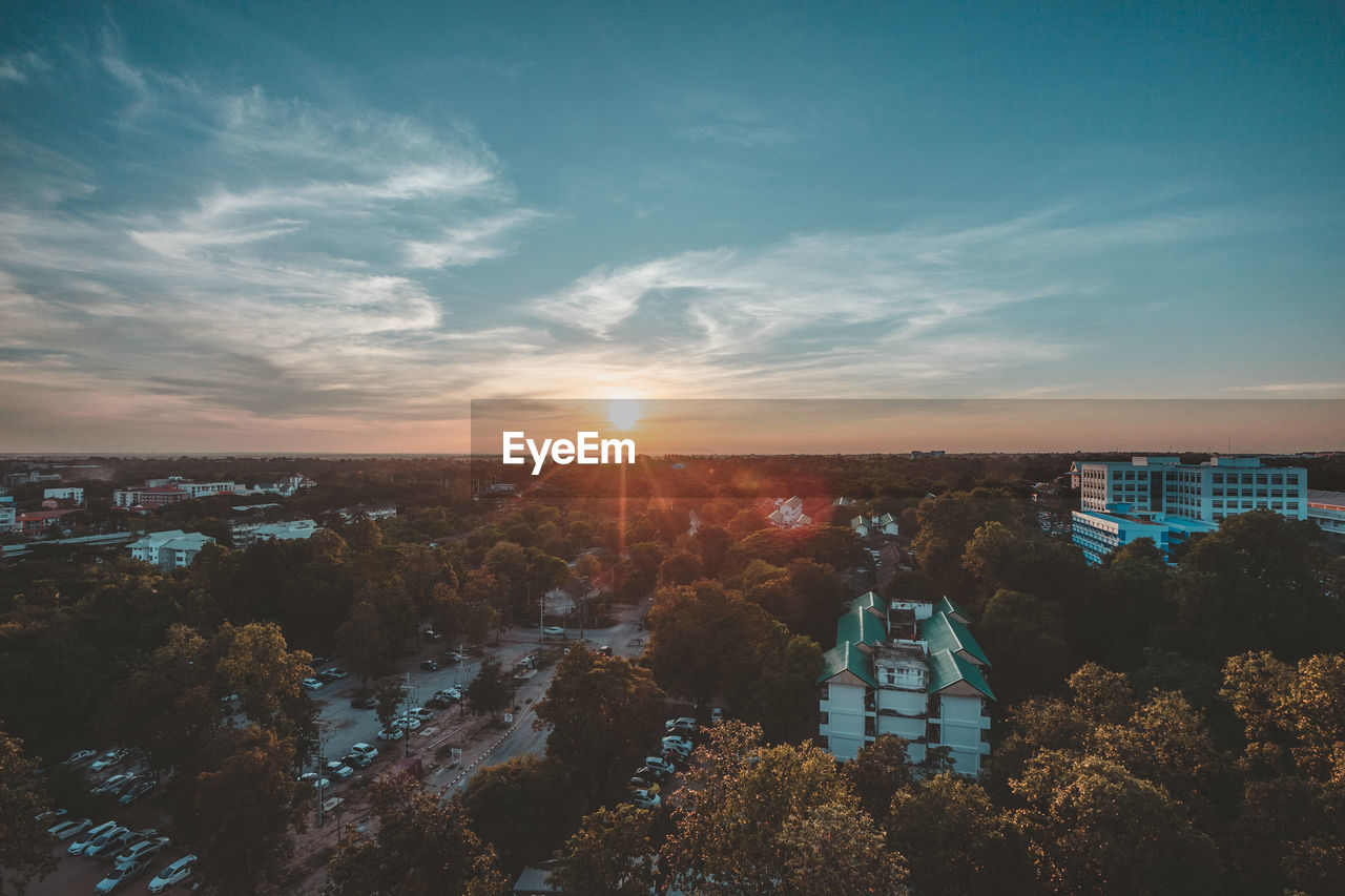 Aerial view of city against sky during sunset