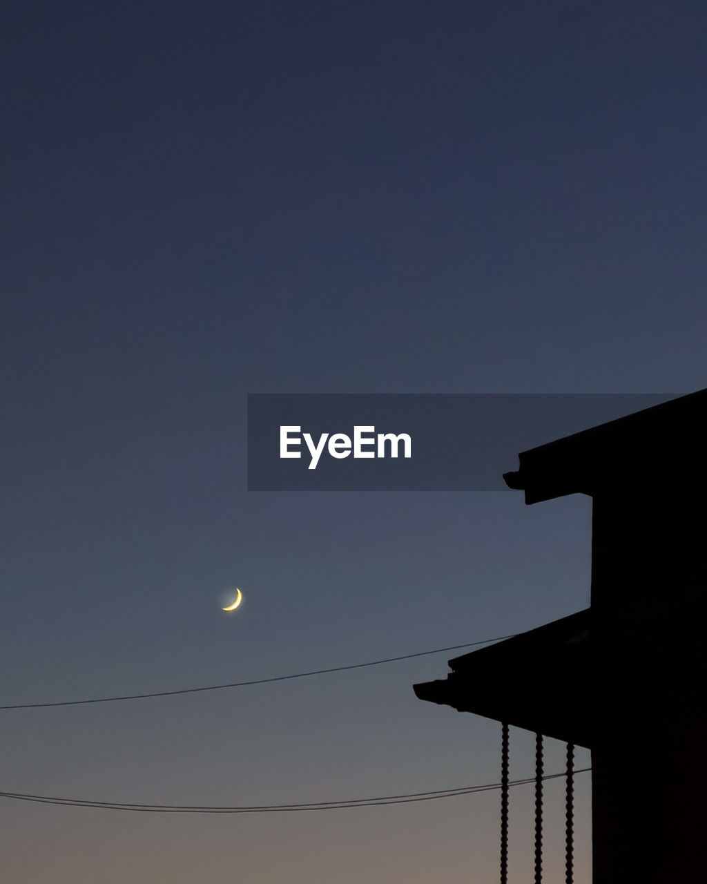 Low angle view of silhouette moon against sky at night