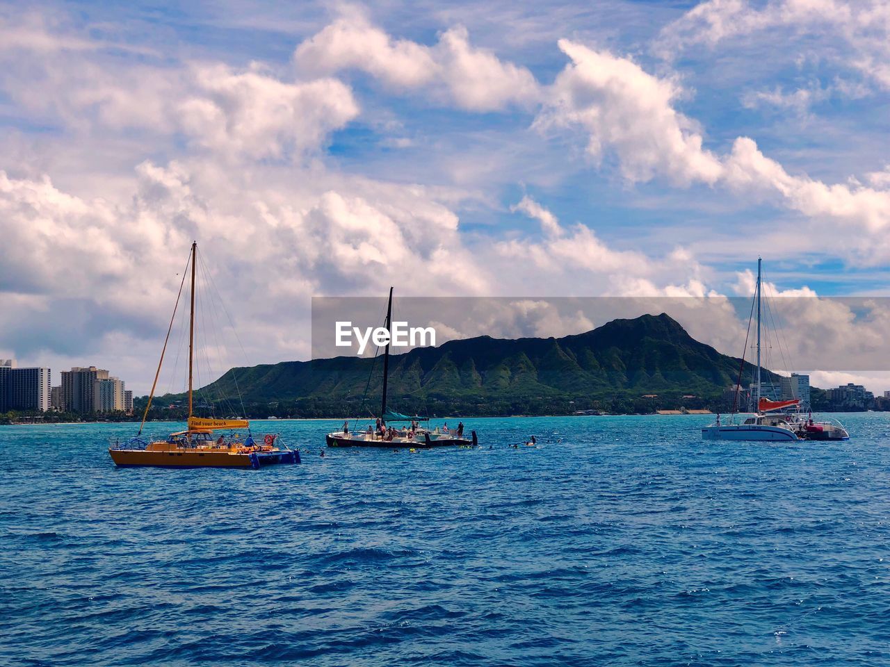 SAILBOATS MOORED ON SEA AGAINST SKY