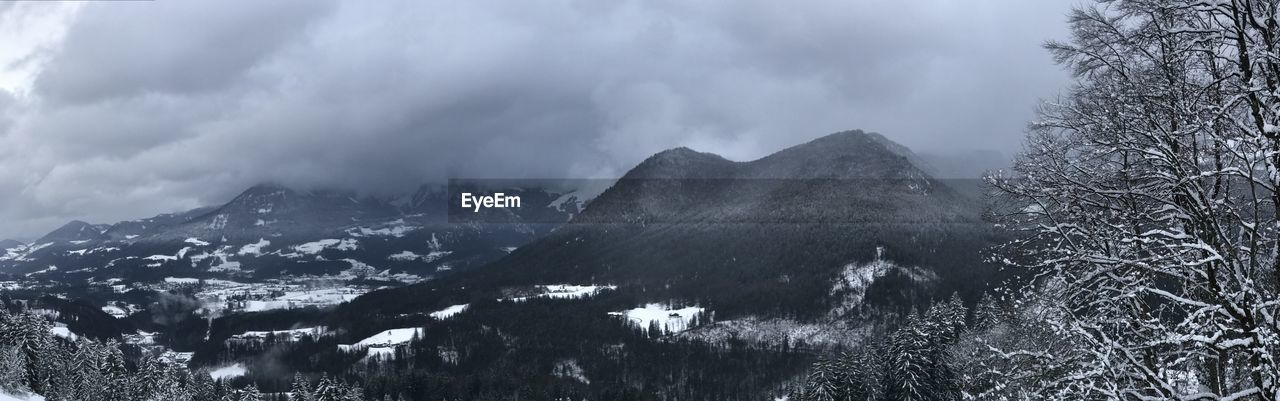 Panoramic shot of trees and mountains against sky