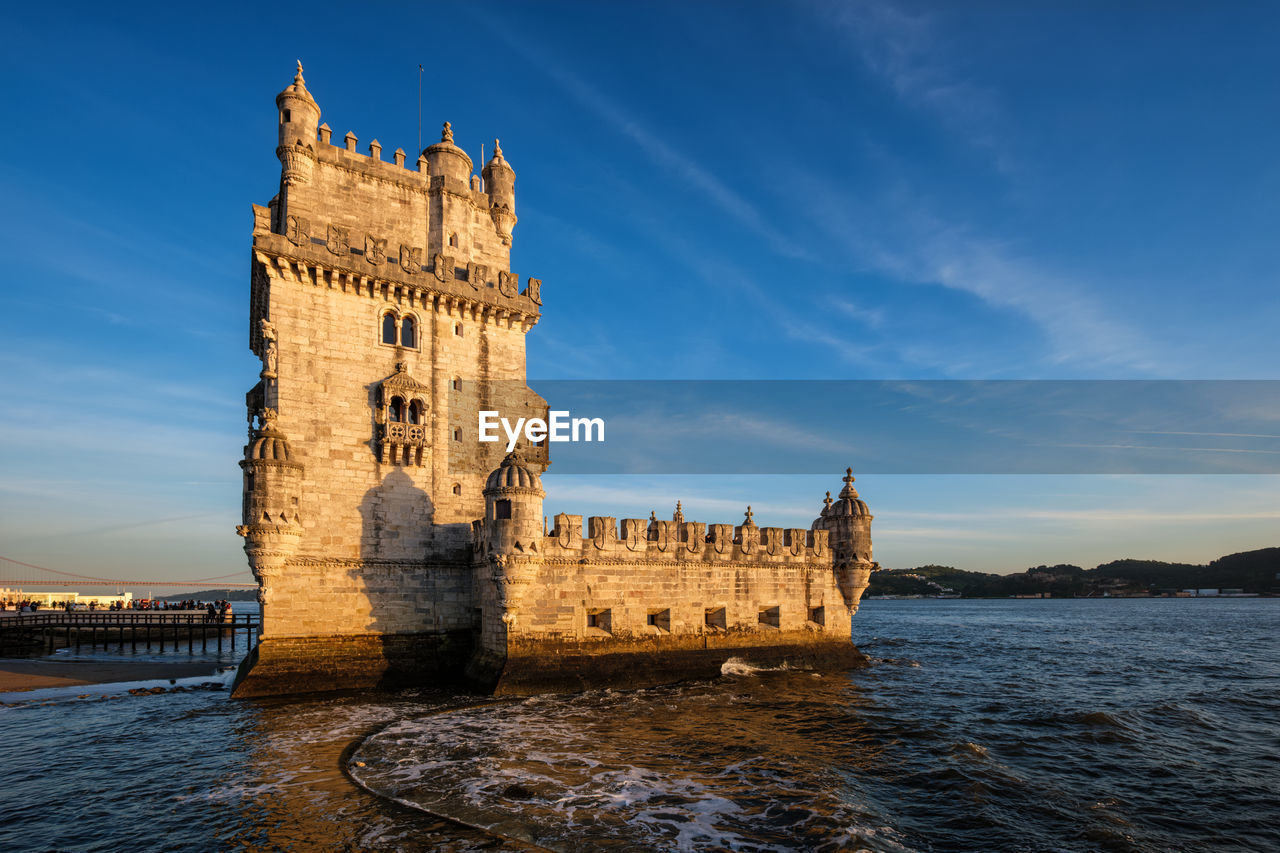 architecture, sky, built structure, travel destinations, water, building exterior, tower, history, the past, landmark, nature, sea, travel, building, city, castle, reflection, cloud, tourism, blue, no people, evening, outdoors, sunset, clock tower, dusk, fort, old, bridge, water castle