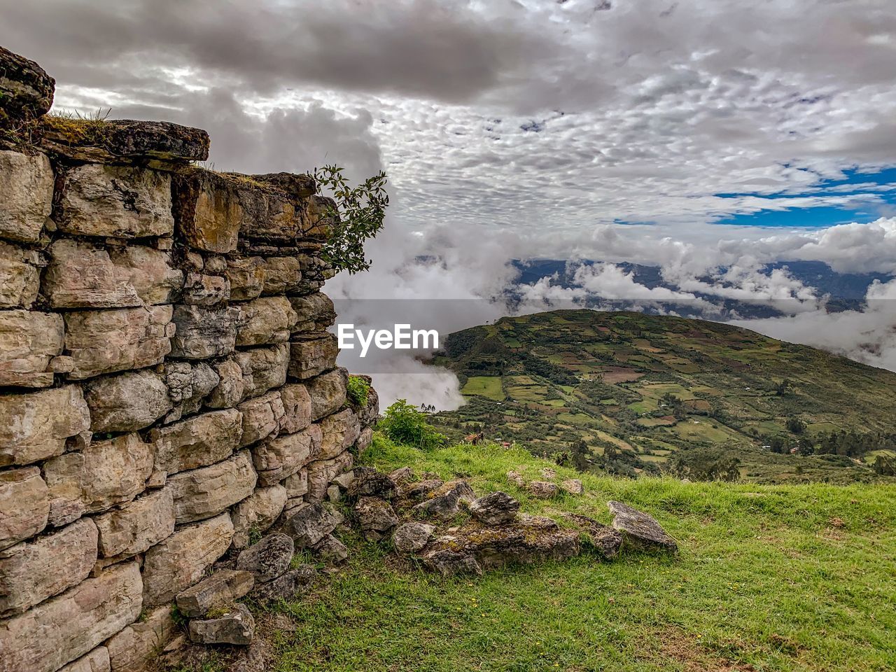 Scenic view of stone wall against sky