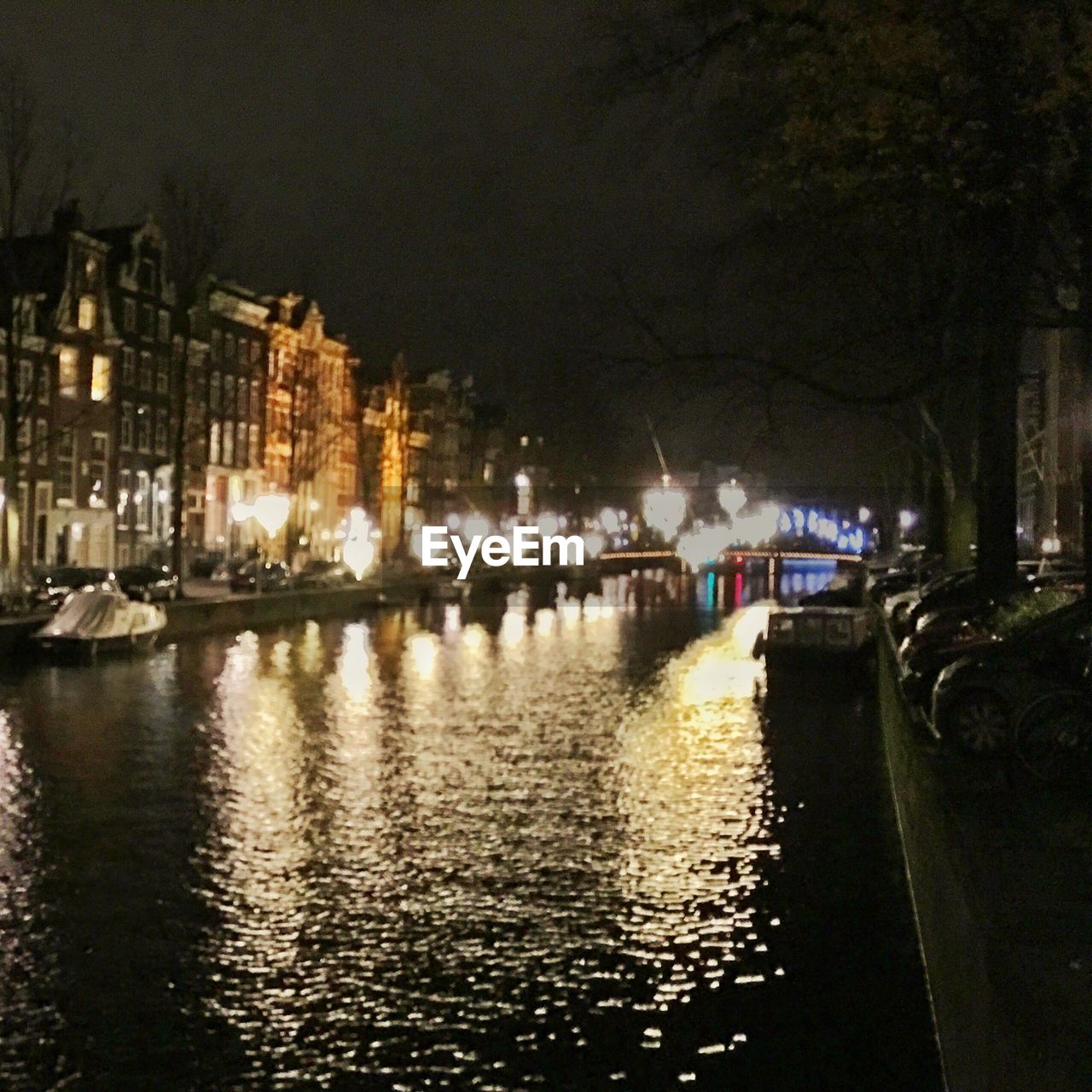 REFLECTION OF ILLUMINATED BUILDINGS IN WATER AT NIGHT