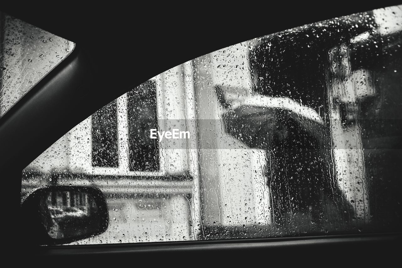 Close-up of car window during rainfall