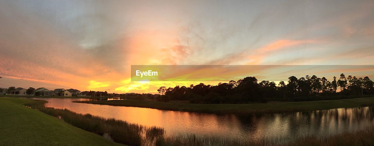 Scenic shot of calm lake at sunset