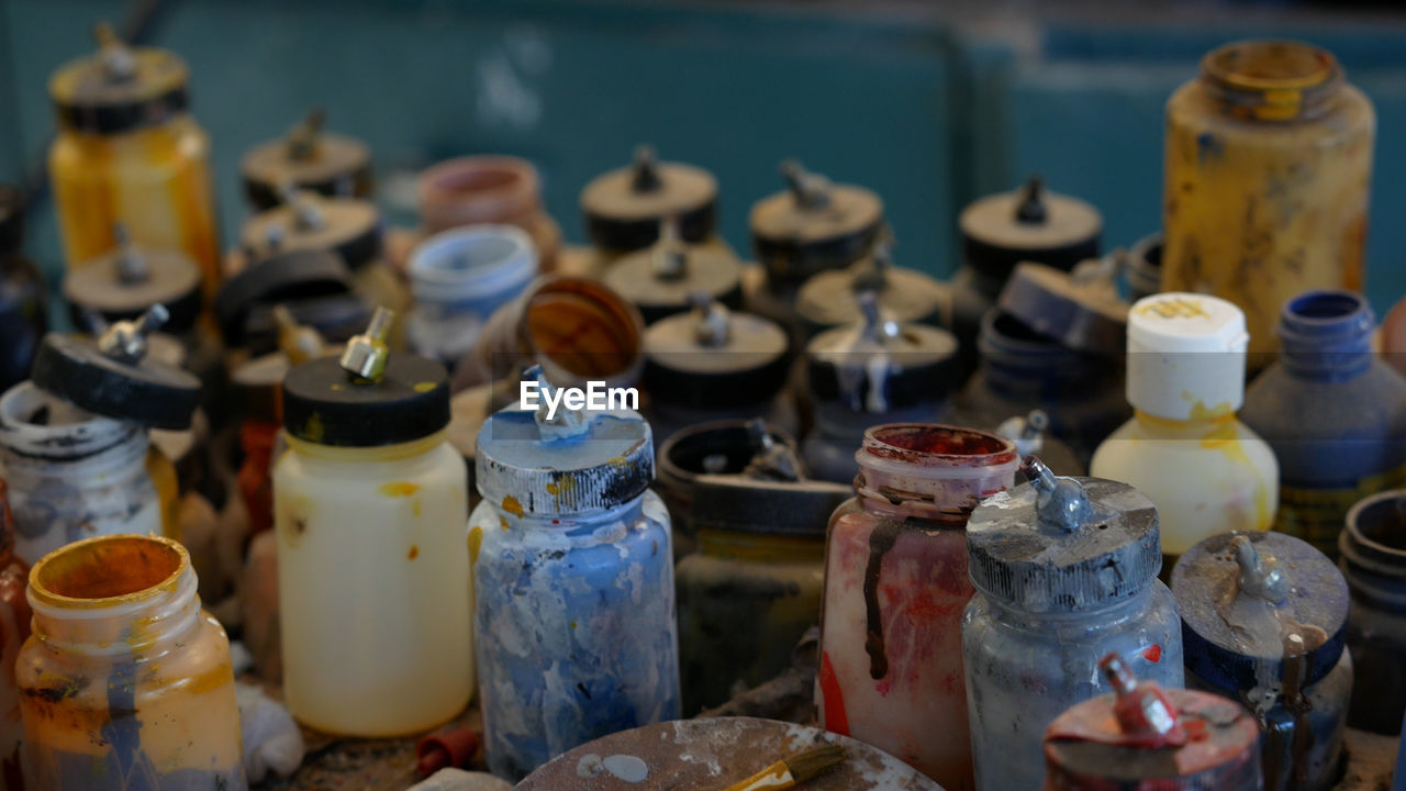 CLOSE-UP OF BOTTLES ON TABLE AT MARKET