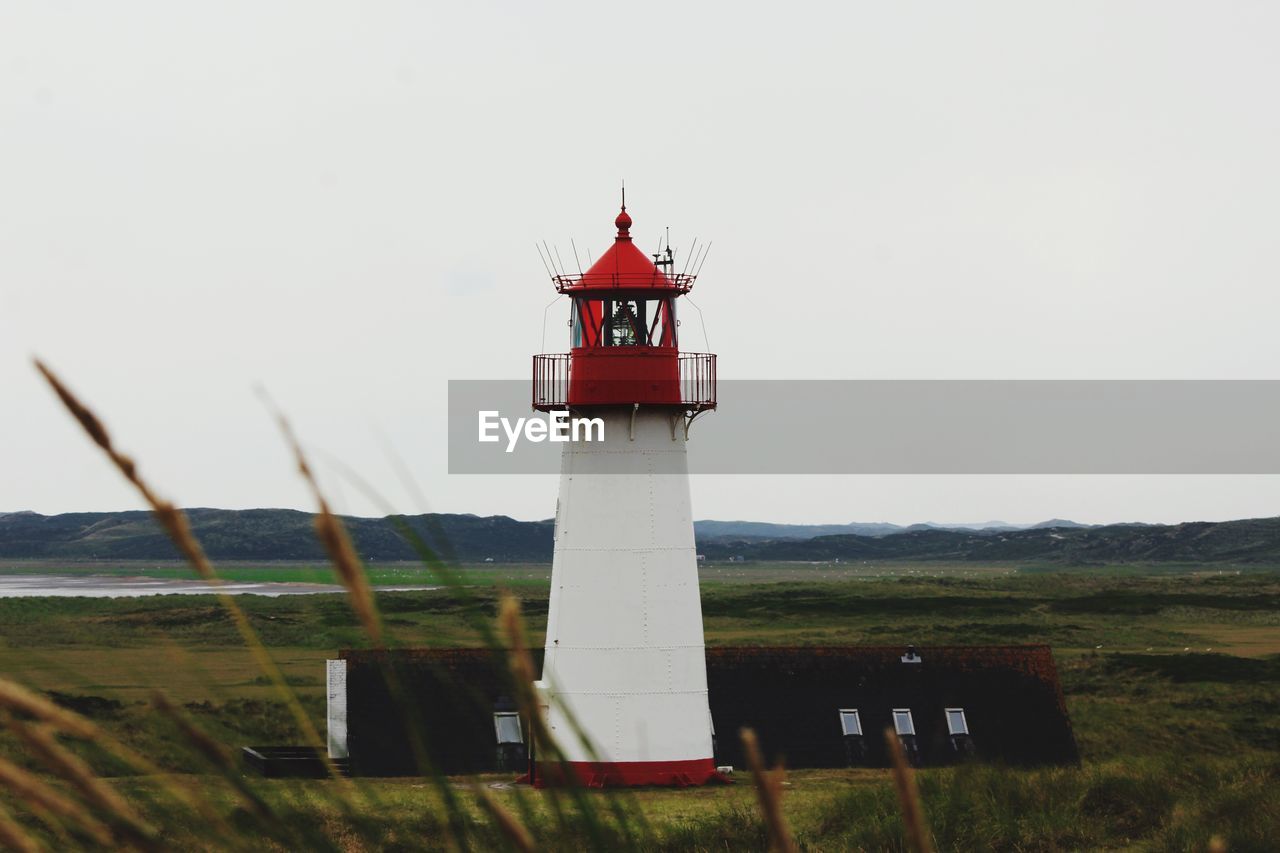 LIGHTHOUSE AND GRASS AGAINST SKY