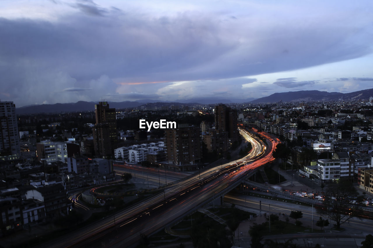 High angle view of illuminated street amidst buildings in city