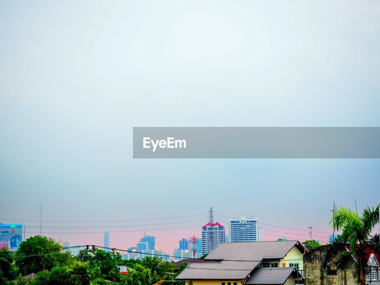 Buildings against clear sky at dusk