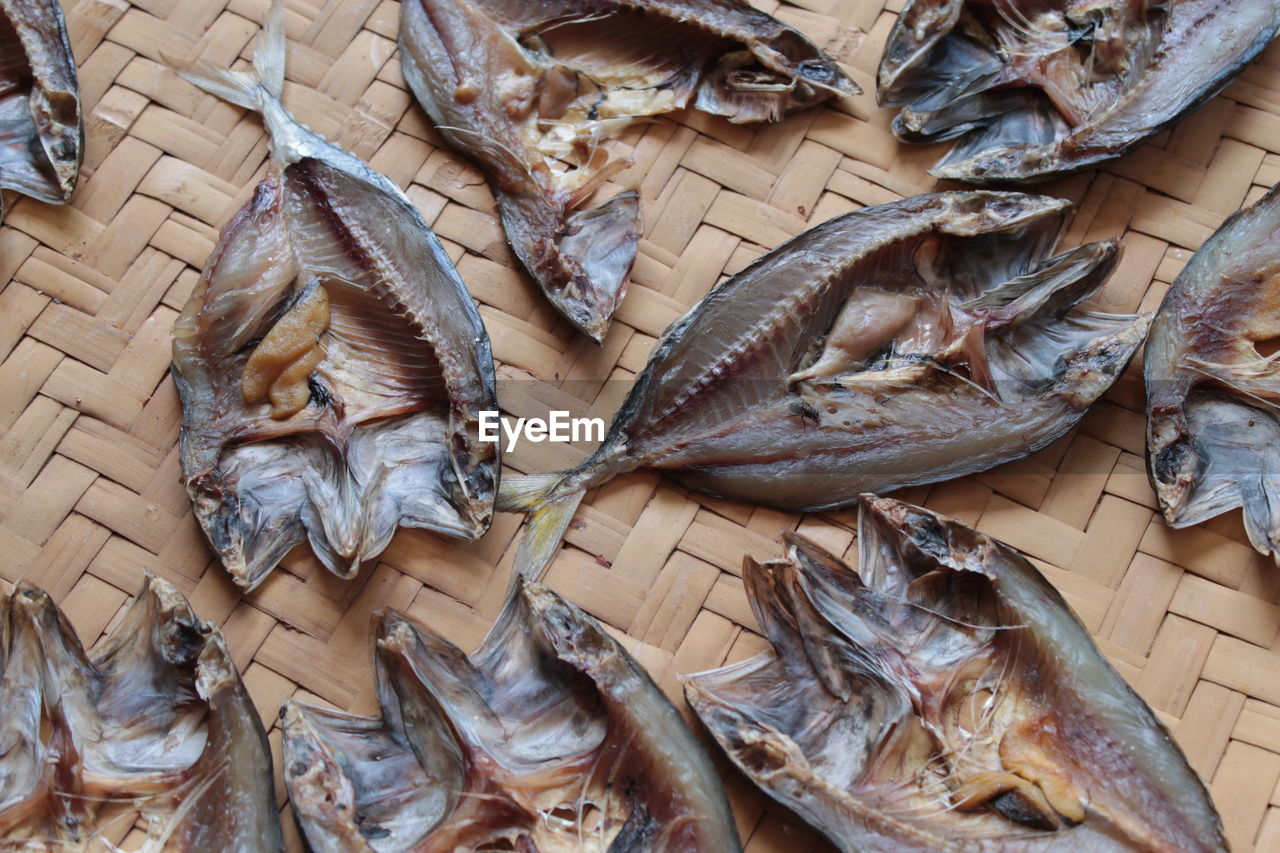 High angle view of dried fish on wicker plate