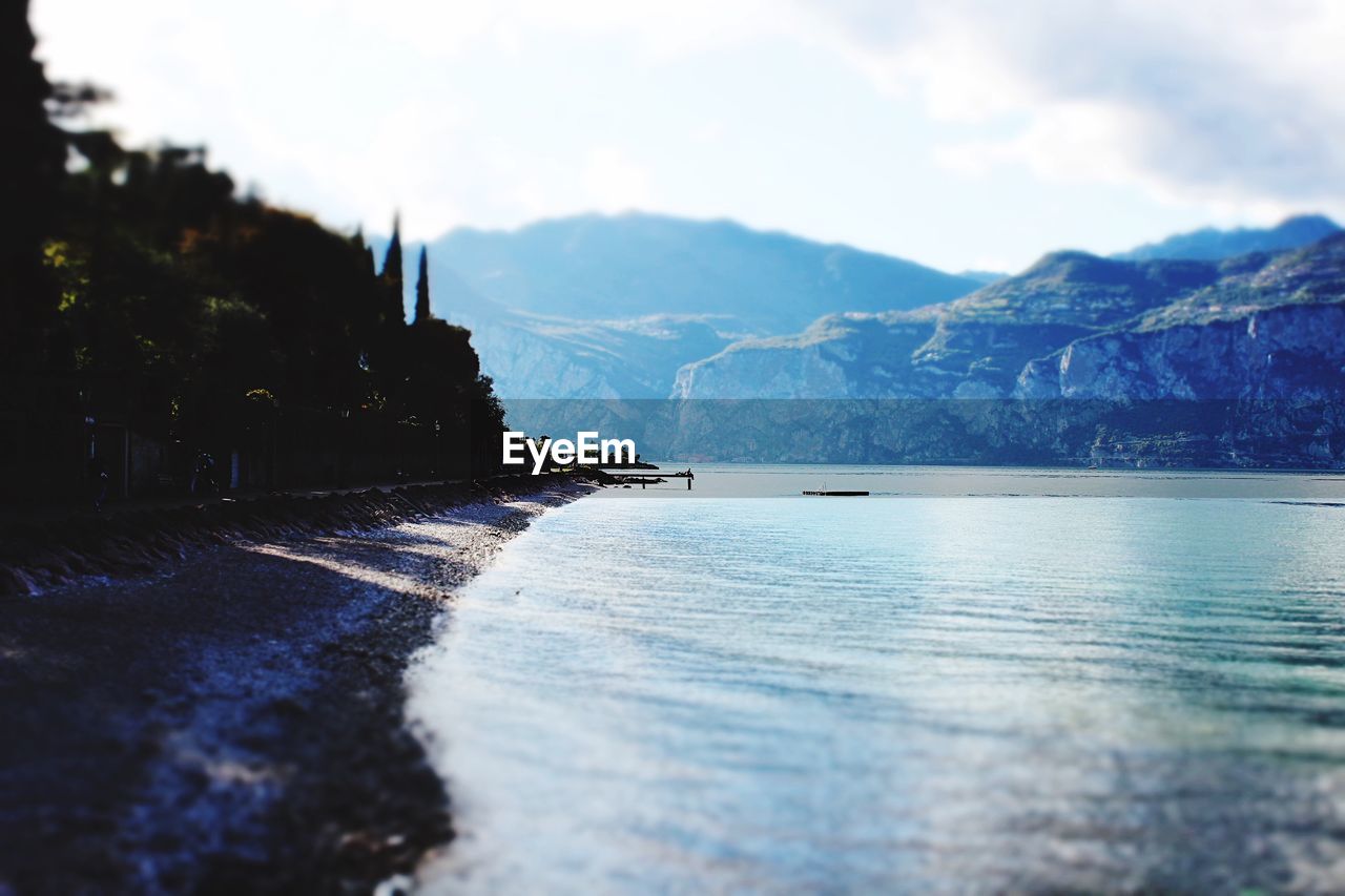 Scenic view of sea and mountains against sky