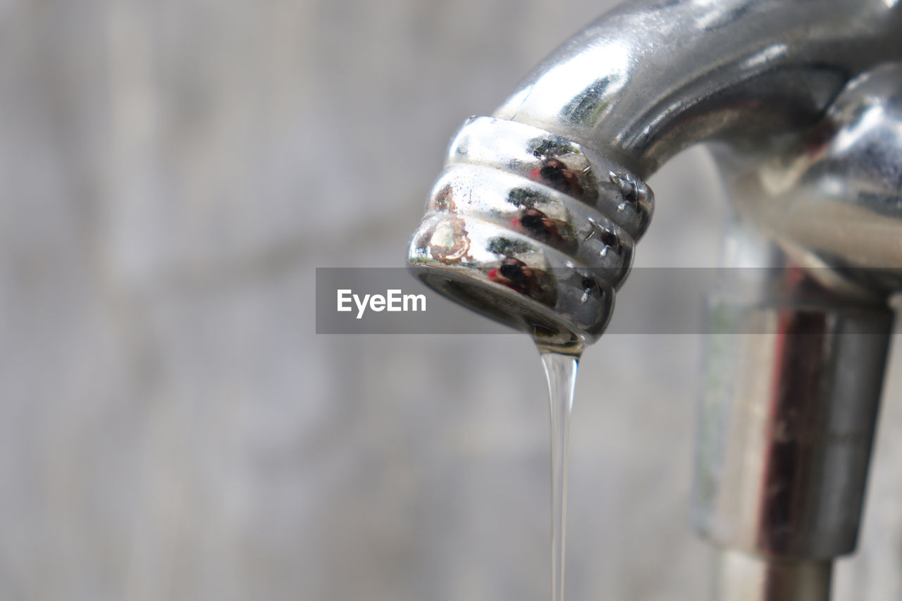 CLOSE-UP OF WATER DROP FROM FAUCET